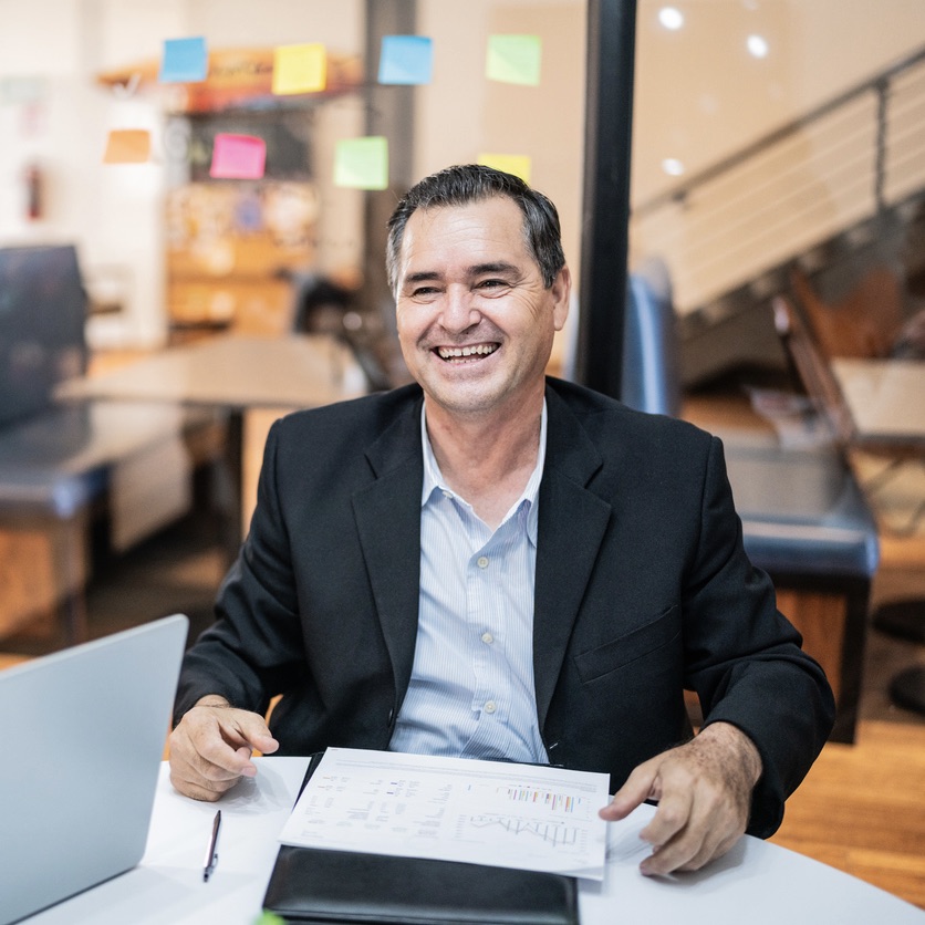 Mature businessman celebrating with his coworkers on a meeting at office